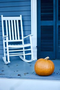 Fall pumpkins on a contrasting blue porch