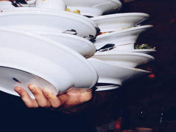 Cropped image of waiter holding plates at restaurant