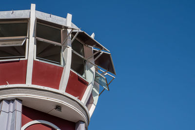 Low angle view of building against clear blue sky