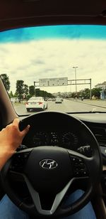 Close-up of hand on car windshield