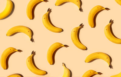 Yellow bananas pattern on a trendy beige background. summer freshness, natural snack, organic.