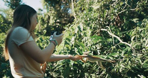 Side view of woman against plants