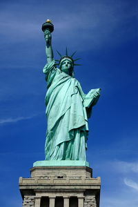 Low angle view of statue against blue sky