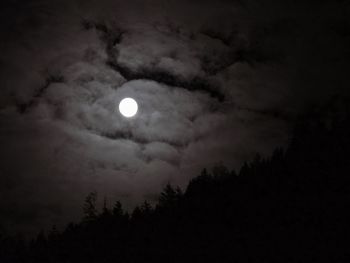 Low angle view of moon in sky at night