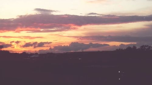 Silhouette landscape against sky during sunset