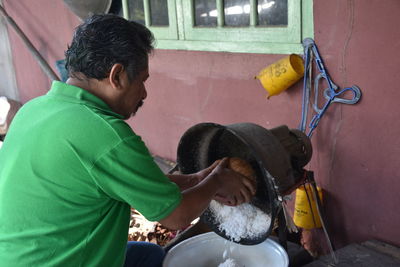 Side view of a man holding umbrella