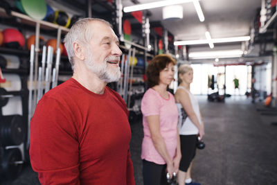 Group of fit seniors in gym working out with kettlebells