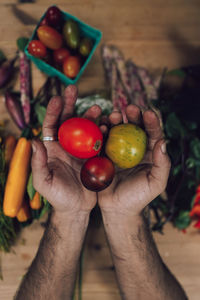 Midsection of man holding fruits