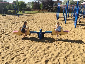 Children playing on sand at playground