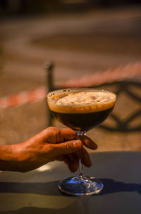 Close-up of hand holding cold shaked coffee