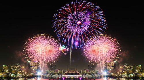 Firework display over city at night