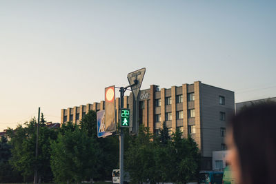 Low angle view of road sign against buildings