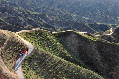 High angle view of people walking on mountain road