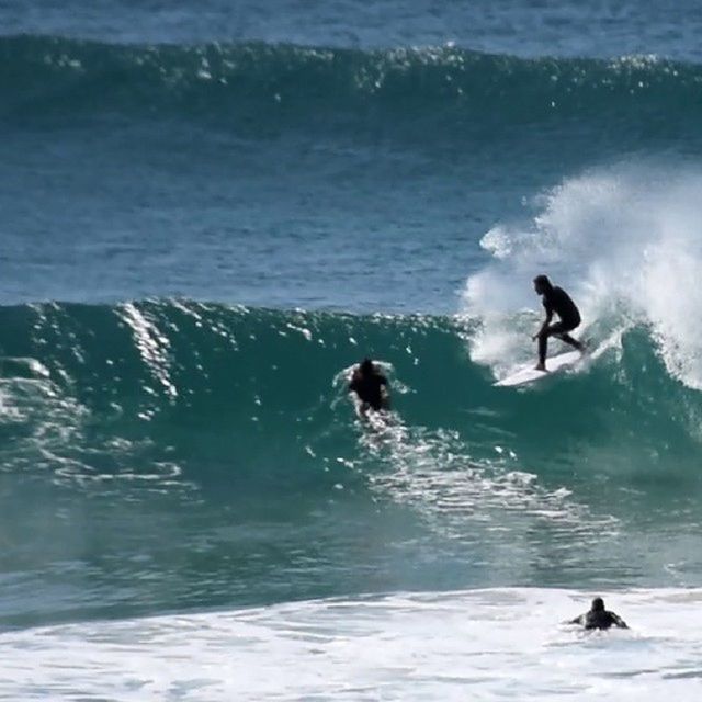 water, lifestyles, leisure activity, waterfront, men, full length, enjoyment, vacations, sea, motion, silhouette, wave, splashing, surfboard, jumping, fun, nature