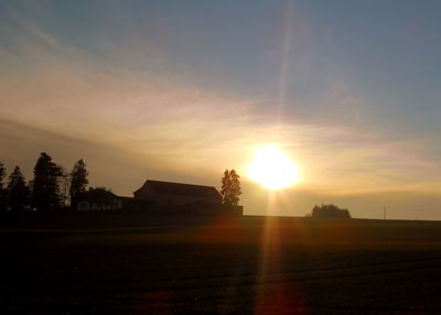 Scenic view of field against sky during sunset