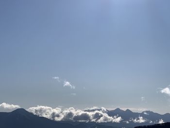 Low angle view of snowcapped mountains against sky