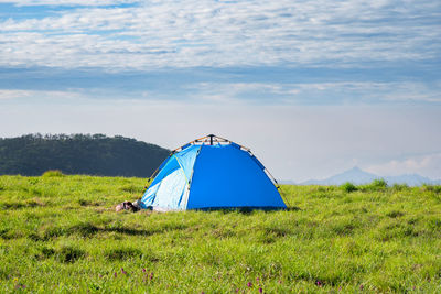 Tent on field against sky