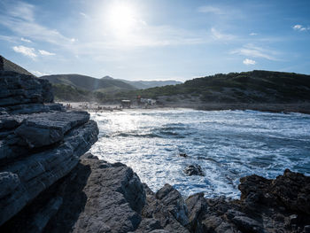 Scenic view of sea and mountains against sky