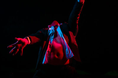 Man standing against black background