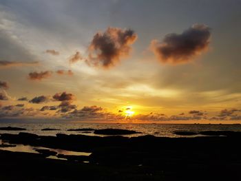 Scenic view of beach against sky during sunset