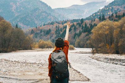 Rear view of man standing on shore