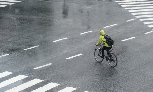 Man riding bicycle on road