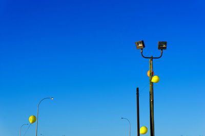 Low angle view of street light against clear blue sky