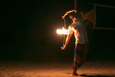 Man photographing fire at night