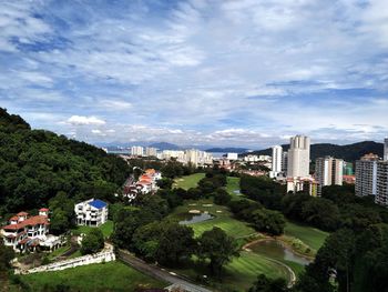 High angle view of buildings and trees against sky