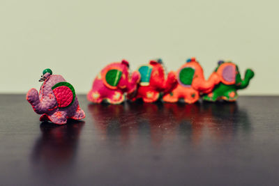 Close-up of toys on table against wall