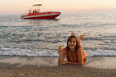 Portrait of young woman sitting on beach