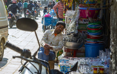 Man sitting at market stall