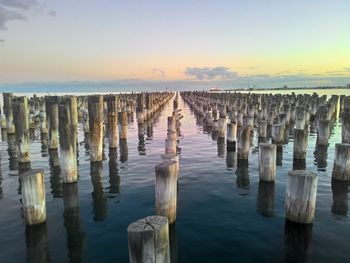 View of wooden posts in sea