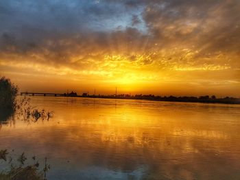 Scenic view of lake against orange sky