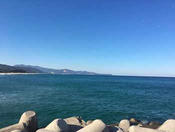 Scenic view of sea against clear blue sky