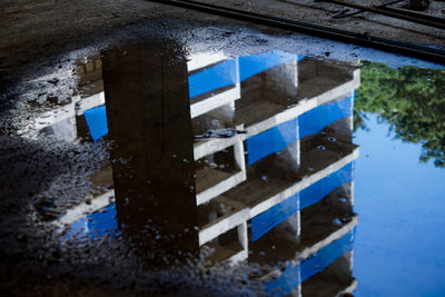 Reflection of building in puddle