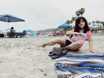 Young woman sitting on beach