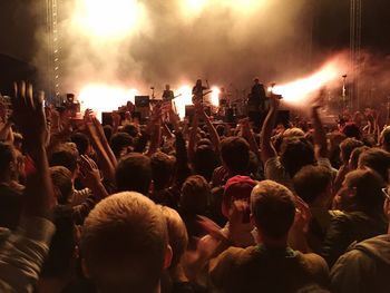 People enjoying music concert at night