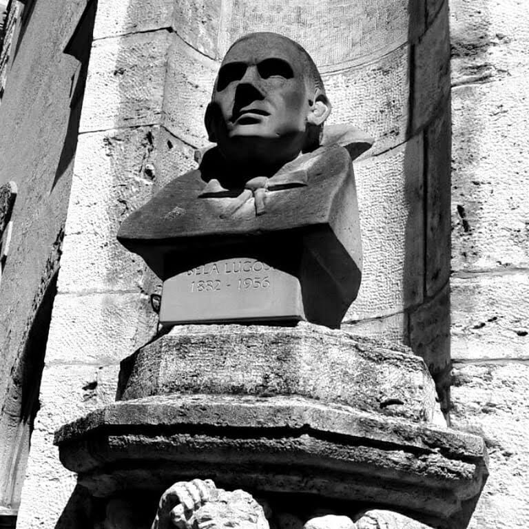 black, black and white, monochrome photography, monochrome, architecture, statue, sculpture, human representation, built structure, white, sitting, representation, temple, male likeness, day, history, religion, monument, the past, low angle view, spirituality, craft, belief, human face, one person, creativity, outdoors, building, person, building exterior, wall - building feature, old, temple - building, place of worship, child, stone material