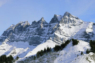 Scenic view of snowcapped mountains against clear sky