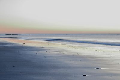 Scenic view of beach against clear sky