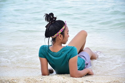 Boy sitting on beach