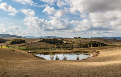 Road amidst field against sky