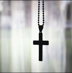 Close-up of cross against blurred background