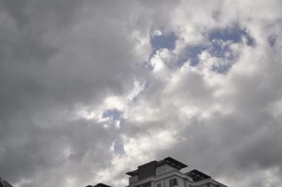 Low angle view of building against cloudy sky