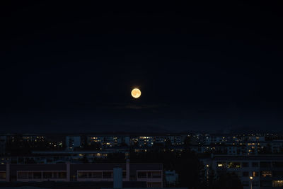 Illuminated cityscape against sky at night