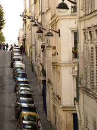 Vehicles on road amidst buildings in city