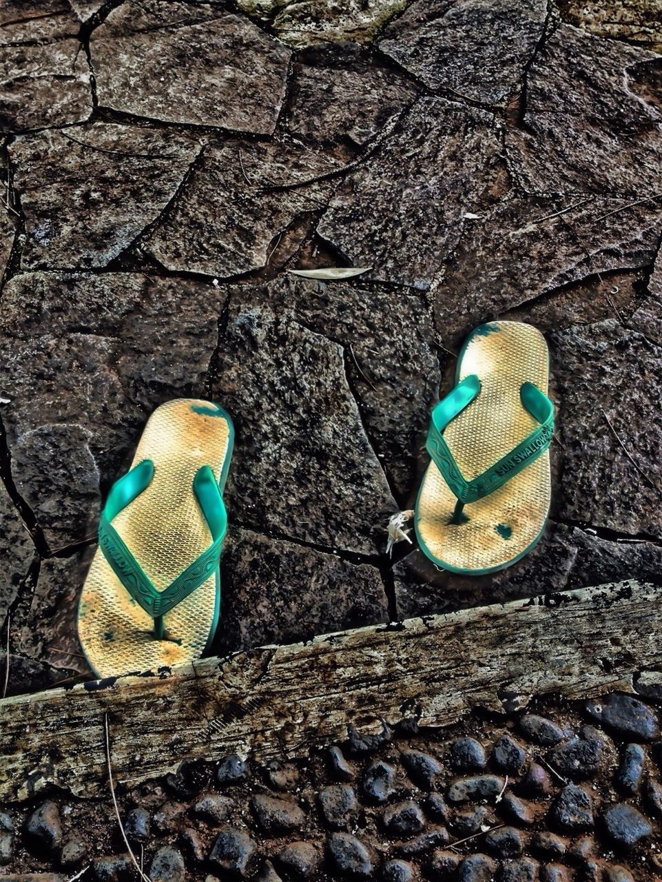 blue, high angle view, day, outdoors, stone - object, sunlight, no people, peacock, still life, close-up, cobblestone, ground, shoe, street, wildlife, toy, animals in the wild, animal representation, multi colored, rock - object