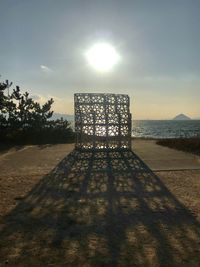 Sunlight falling on walkway against sky on sunny day