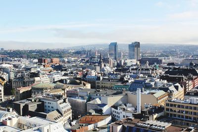 High angle view of modern buildings in city against sky